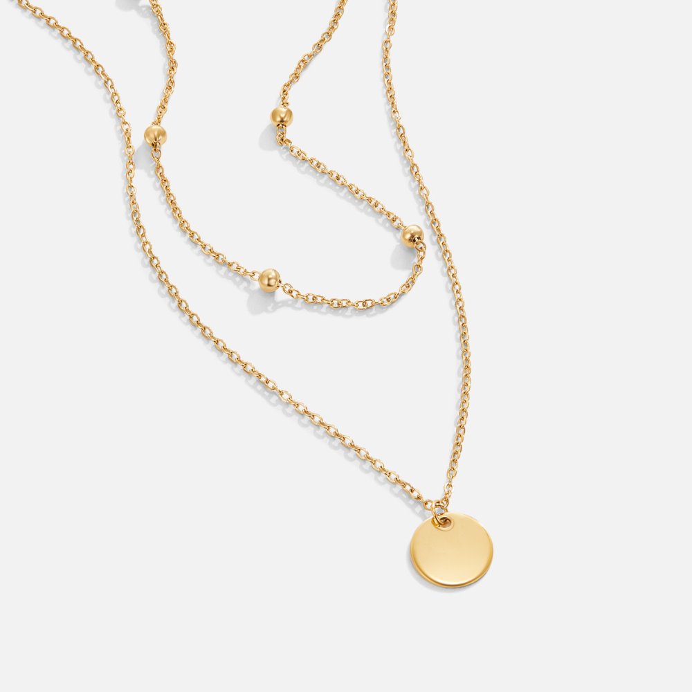 Halsband med skivformade hängen i flera lager